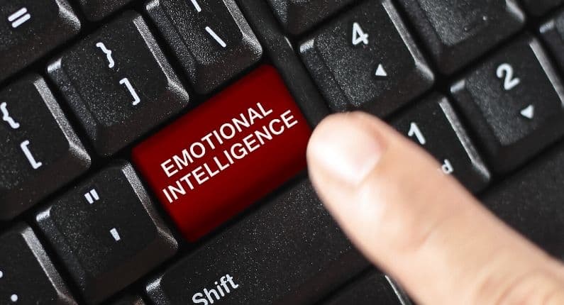 New Times New focus on EI | black keyboard with red button saying emotional intelligence